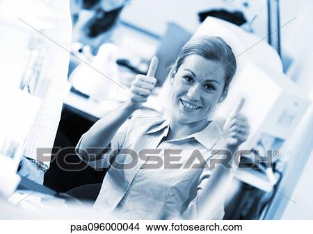 Woman giving thumbs up sign, smiling at camera, close-up, portrait View Large Photo Image Picture - Woman giving thumbs up sign, smiling at camera, close-up, portrait. Fotosearch
