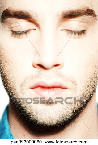Stock Image - Man's face with closed eyes, close-up. Fotosearch