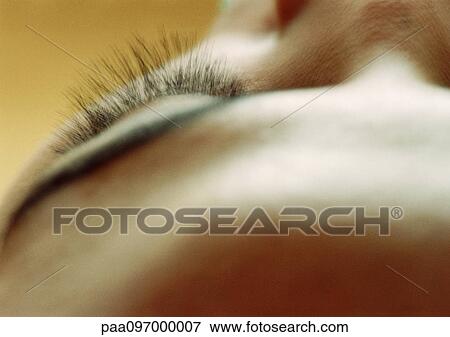 Stock Photo - Woman's eyelashes, high angle view, close-up. Fotosearch