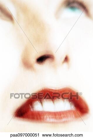 Stock Image - Woman's face, looking up, partial view, close-up, blurred. Fotosearch