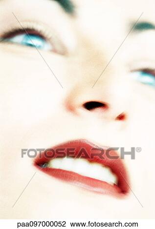 Stock Image - Woman's face, partial view, close-up, blurred. Fotosearch