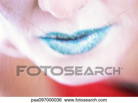 Stock Photograph - Woman's lips with green lipstick, close-up. Fotosearch