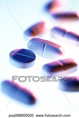 Stock Image - A variety of medicine tablets, close-up, blurred. Fotosearch