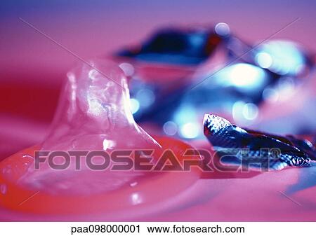 Condom and torn wrapper, close-up, blurred background View Large Photo Image Stock Image - Condom and torn wrapper, close-up, blurred background. Fotosearch