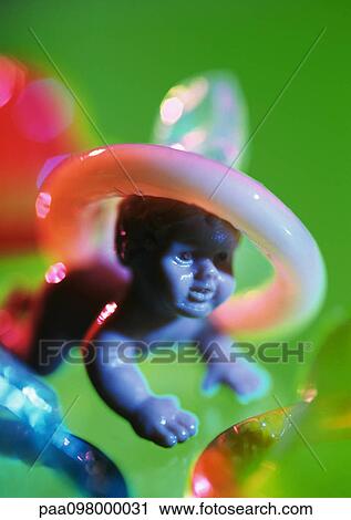 Condom on plastic baby doll's head View Large Photo Image Stock Image - Condom on plastic baby doll's head. Fotosearch