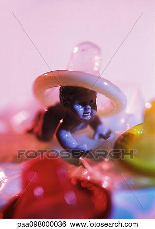 Condom on plastic baby doll's head View Large Photo Image Stock Photograph - Condom on plastic baby doll's head. Fotosearch