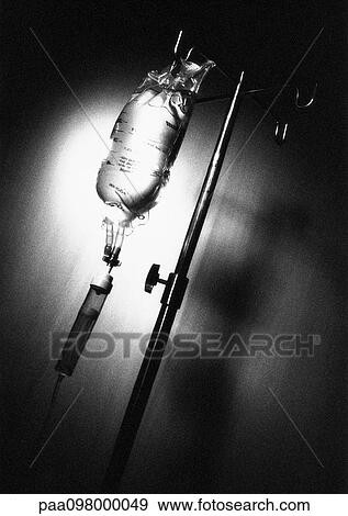 Stock Photo - Intravenous bag and stand, close-up, B&W. Fotosearch