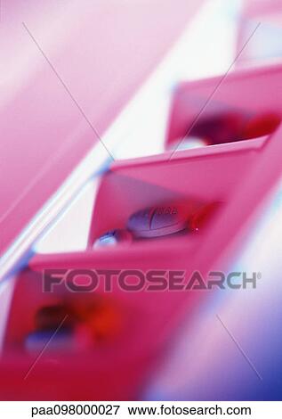 Stock Photo - Medicine tablets and capsules in pill box, close-up. Fotosearch