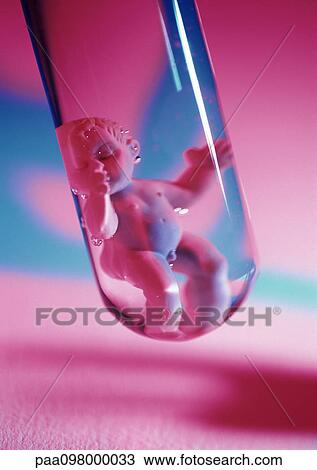 Stock Image - Plastic baby doll in test tube, close-up. Fotosearch