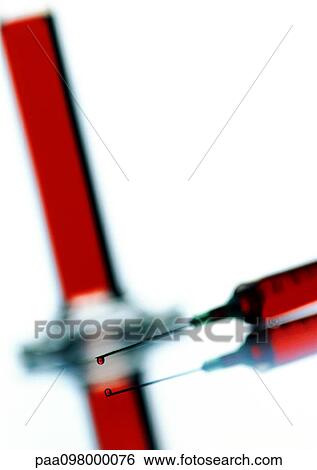 Stock Photograph - Syringe and cylinder, close-up. Fotosearch