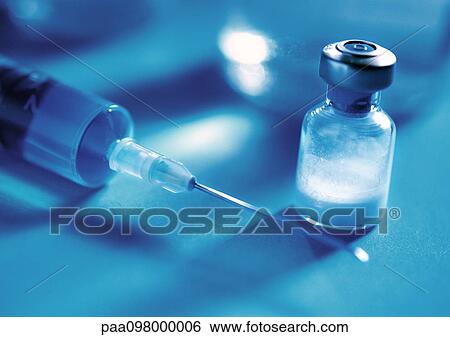 Stock Photograph - Syringe and glass vial, close-up. Fotosearch
