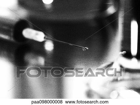 Stock Photo - Syringe, close-up, blurred, b&w. Fotosearch
