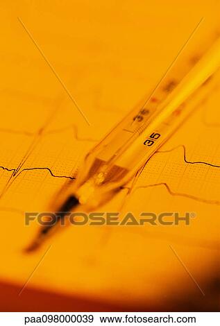 Stock Photo - Thermometer on graph, close-up. Fotosearch
