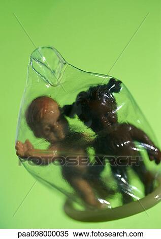Two plastic baby dolls standing under condom, close-up View Large Photo Image Stock Photography - Two plastic baby dolls standing under condom, close-up. Fotosearch