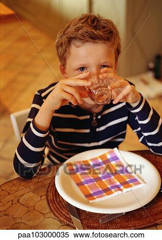 Child drinking at table, portrait View Large Photo Image Stock Photography - Child drinking at table, portrait. Fotosearch