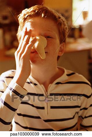 Child holding fake nose to face, portrait View Large Photo Image Stock Photo - Child holding fake nose to face, portrait. Fotosearch
