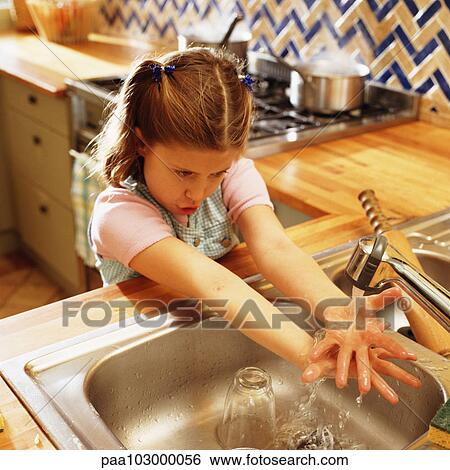 Stock Photograph - Child holding hands under kitchen faucet. Fotosearch