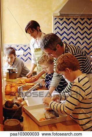 Family cooking in kitchen View Large Photo Image Stock Image - Family cooking in kitchen. Fotosearch