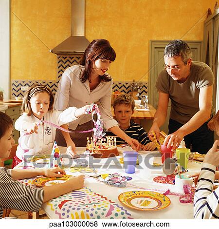 Family gathered around table for birthday party View Large Photo Image Stock Photo - Family gathered around table for birthday party. Fotosearch