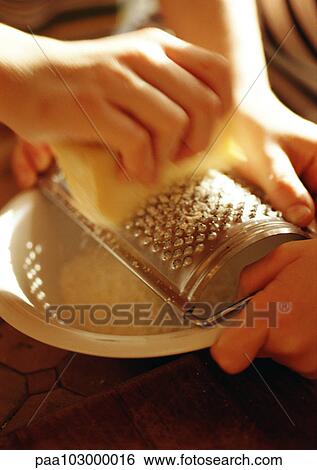 Hands grating cheese over bowl, close-up View Large Photo Image Stock Photograph - Hands grating cheese over bowl, close-up. Fotosearch