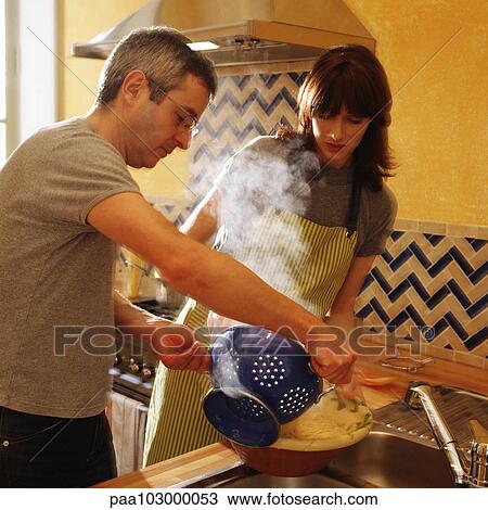 Man and woman putting pasta in bowl View Large Photo Image Stock Image - Man and woman putting pasta in bowl. Fotosearch