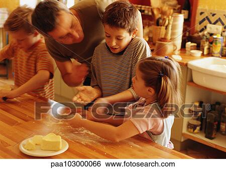 Man helping children in kitchen, blurred motion View Large Photo Image Stock Photograph - Man helping children in kitchen, blurred motion. Fotosearch
