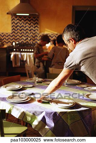 Man setting table, children standing in background View Large Photo Image Stock Photography - Man setting table, children standing in background. Fotosearch