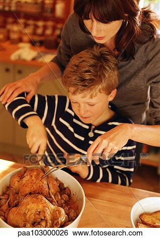 Woman and child carving chickens View Large Photo Image Stock Photograph - Woman and child carving chickens. Fotosearch