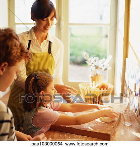 Woman and children cooking View Large Photo Image Picture - Woman and children cooking. Fotosearch