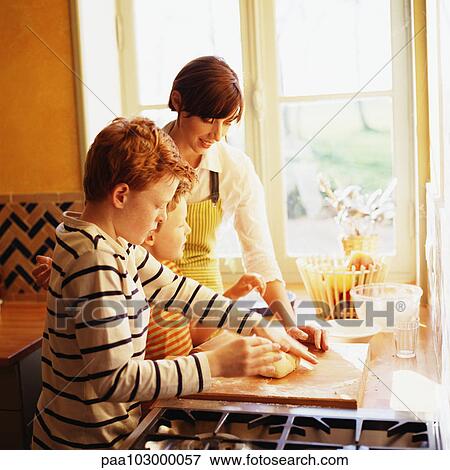Woman and children making pastry, side view View Large Photo Image Stock Photo - Woman and children making pastry, side view. Fotosearch