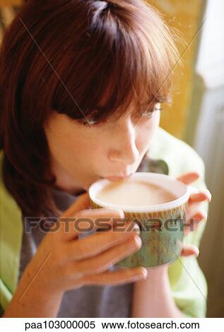 Stock Photography - Woman drinking from mug, close-up. Fotosearch