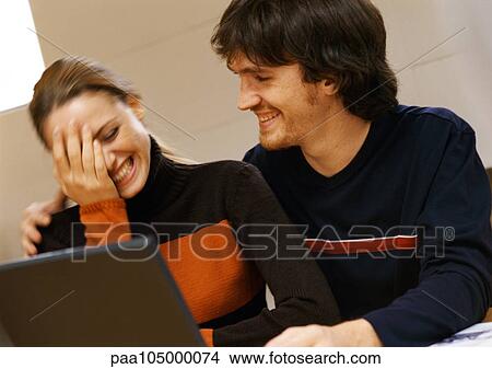 Man and woman smiling, woman with hand on face View Large Photo Image Picture - Man and woman smiling, woman with hand on face. Fotosearch