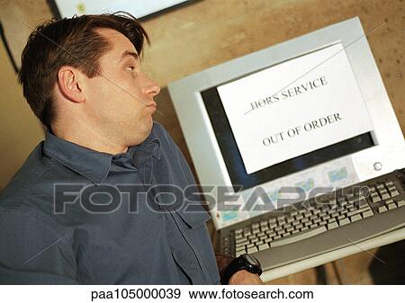Man looking at computer screen with "out of order" sign on screen View Large Photo Image Stock Photo - Man looking at computer screen with "out of order" sign on screen. Fotosearch