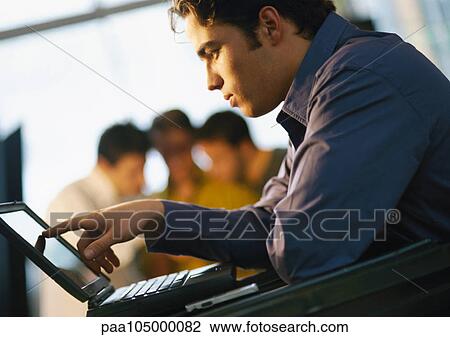 Man looking at laptop computer, side view View Large Photo Image Stock Image - Man looking at laptop computer, side view. Fotosearch