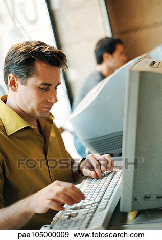 Man using computer View Large Photo Image Stock Photo - Man using computer. Fotosearch