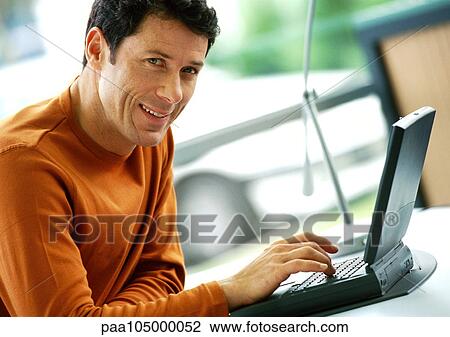 Man using laptop computer, portrait View Large Photo Image Stock Image - Man using laptop computer, portrait. Fotosearch