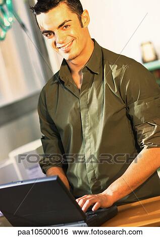 Man using laptop computer, portrait View Large Photo Image Stock Photograph - Man using laptop computer, portrait. Fotosearch