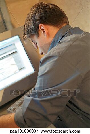 Man working on computer, rear view View Large Photo Image Stock Photo - Man working on computer, rear view. Fotosearch