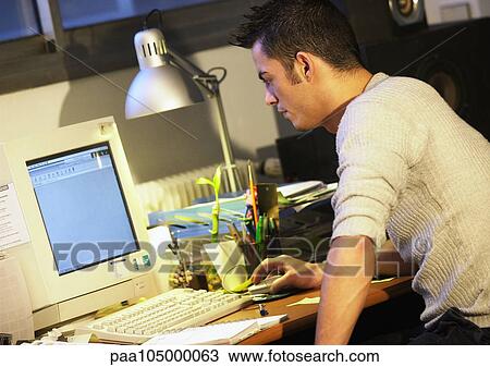 Man working on computer, side view View Large Photo Image Stock Image - Man working on computer, side view. Fotosearch