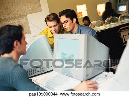People working on computers in cyber cafe View Large Photo Image Picture - People working on computers in cyber cafe. Fotosearch