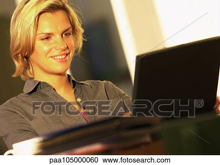 Woman using laptop computer, smiling View Large Photo Image Stock Image - Woman using laptop computer, smiling. Fotosearch