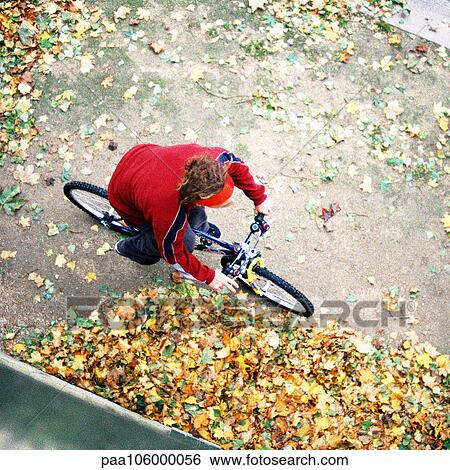 Person riding bike, elevated view View Large Photo Image Stock Photograph - Person riding bike, elevated view. Fotosearch