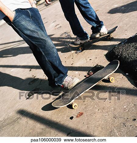 Two people with skateboards, low section View Large Photo Image Stock Photo - Two people with skateboards, low section. Fotosearch