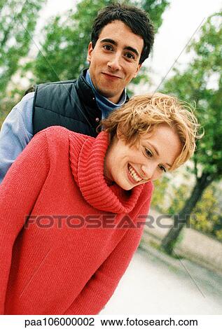 Two young people in park, smiling View Large Photo Image Stock Image - Two young people in park, smiling. Fotosearch