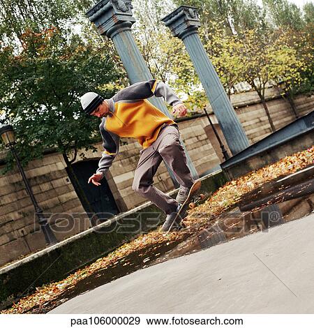 Young man in mid-air on skateboard View Large Photo Image Stock Photo - Young man in mid-air on skateboard. Fotosearch