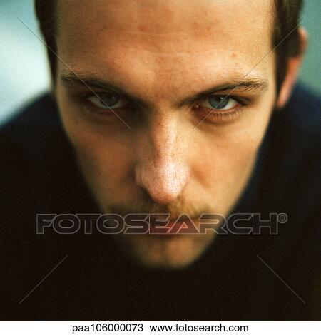Young man looking into camera, close-up, portrait View Large Photo Image Stock Image - Young man looking into camera, close-up, portrait. Fotosearch