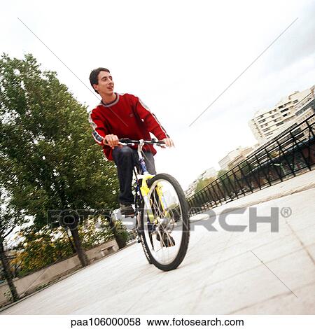 Young man on bike View Large Photo Image Stock Photo - Young man on bike. Fotosearch