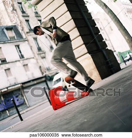 Young man performing skateboard trick View Large Photo Image Stock Photography - Young man performing skateboard trick. Fotosearch