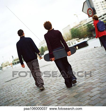 Young people holding skateboards, rear view View Large Photo Image Stock Photo - Young people holding skateboards, rear view. Fotosearch