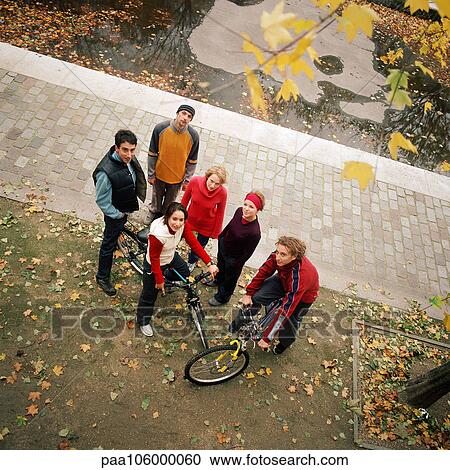 Young people, two with bikes, elevated view View Large Photo Image Stock Image - Young people, two with bikes, elevated view. Fotosearch